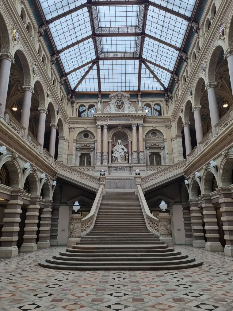 A grand marble staircase inside a historic palace of justice