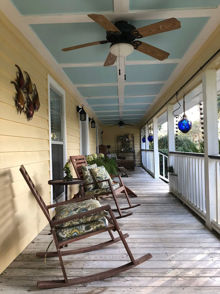 A classic Southern porch with wooden rocking chairs