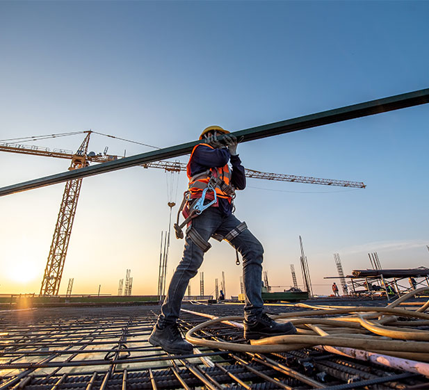 construction worker lifting a metal bar